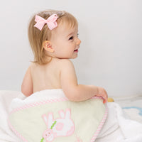 Hooded towel on baby outside of tub, 3 Marthas