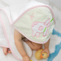 Hooded towel on baby outside of tub playing with rubber ducks, 3 Marthas