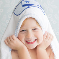Child wearing hooded towel with a blue cowboy hat on the hood, 3 Marthas