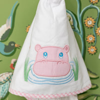 White hooded towel with pink hippo design hanging against a decorative green background, 3 Marthas