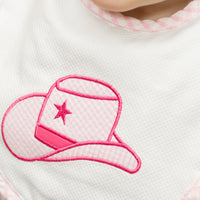 Baby bib with pink cowgirl hat design on a white background