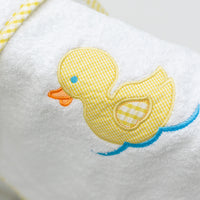 White bath mat with a yellow rubber duck design on side of tub, 3 Marthas