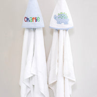 3 Marthas white terrycloth hooded towel with blue and green applique dino and blue check trim for boys. White terrycloth hooded towel with blue seersucker stripes for boys.