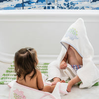 3 Marthas white terrycloth hooded towel with pink dino applique and pink trim for girls. White terrycloth hooded towel with blue dino applique and blue trim for boys.