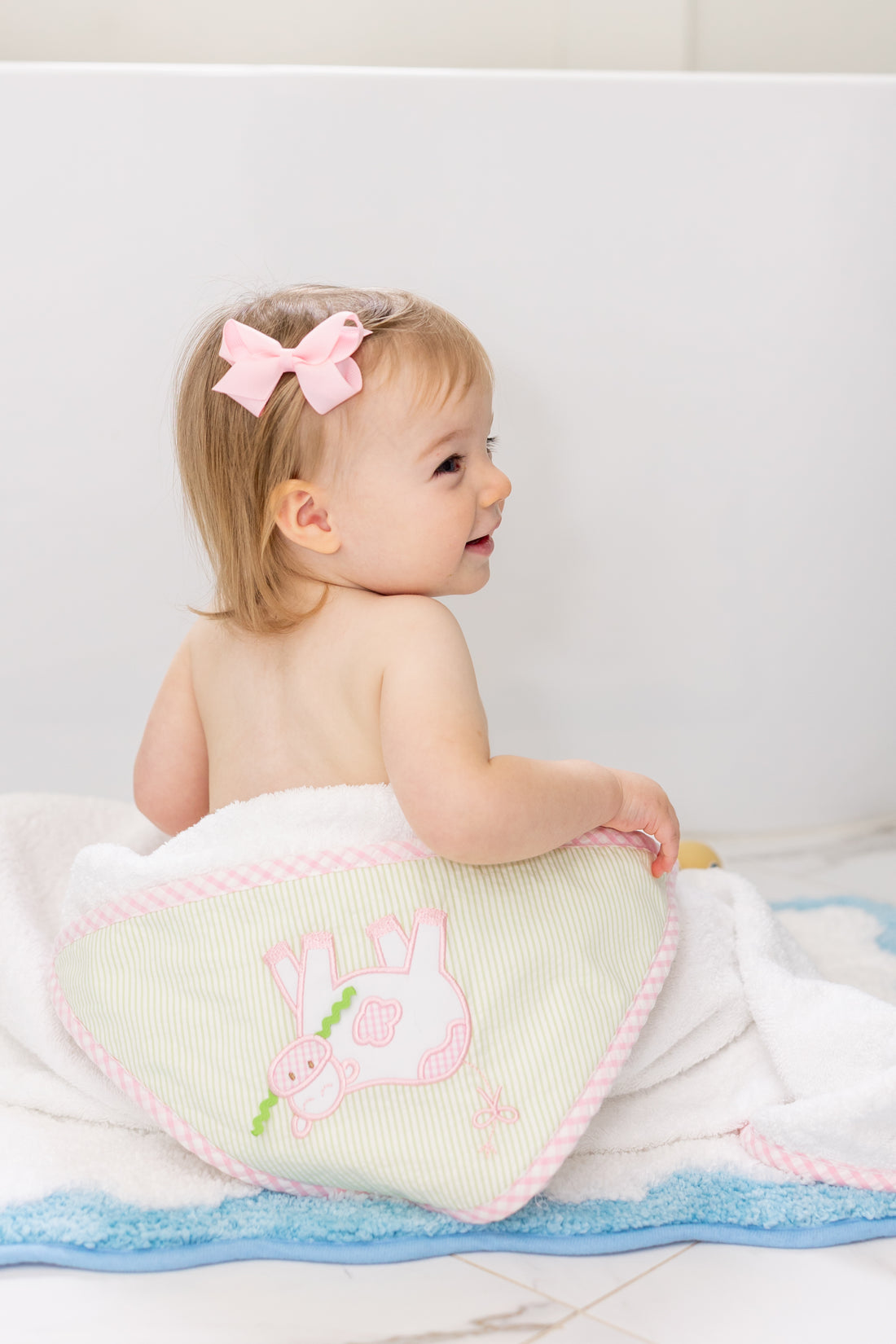 Hooded towel on baby outside of tub, 3 Marthas