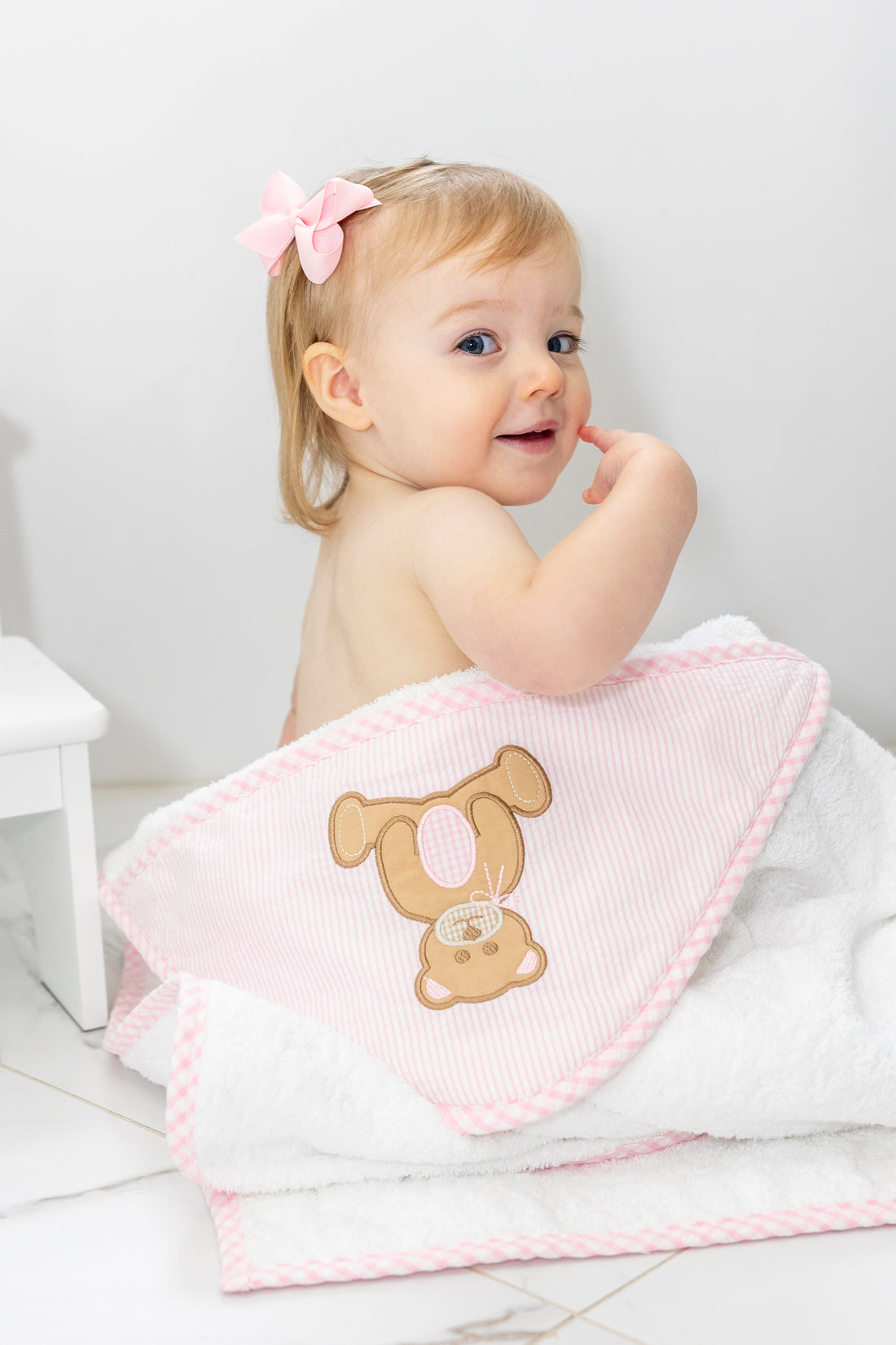 Baby in hooded towel outside of tub, 3 Marthas