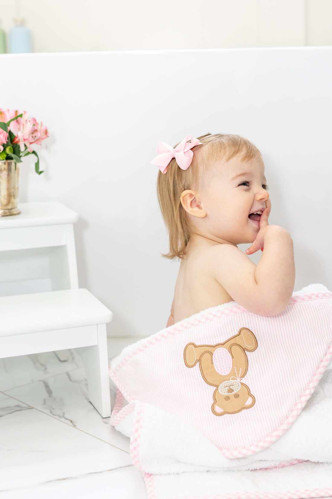 Baby in hooded towel outside of tub, 3 Marthas