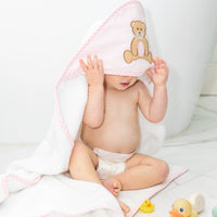 Baby in hooded towel outside of tub, 3 Marthas