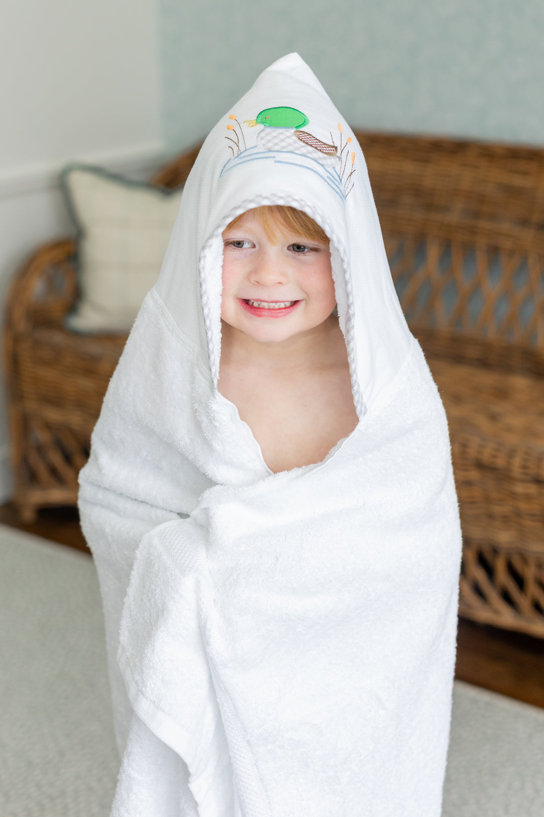 Child wrapped in mallard hooded towel, 3 Marthas