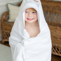 Child wrapped in mallard hooded towel, 3 Marthas