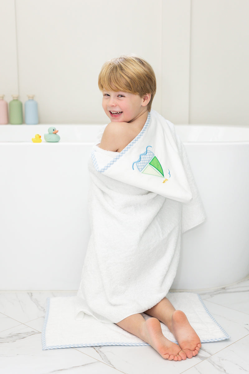 Child wrapped in bath towel featuring sailboat, 3 Marthas