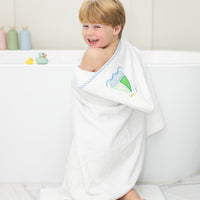 Child wrapped in bath towel featuring sailboat, 3 Marthas