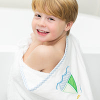 Child wrapped in bath towel featuring sailboat, 3 Marthas