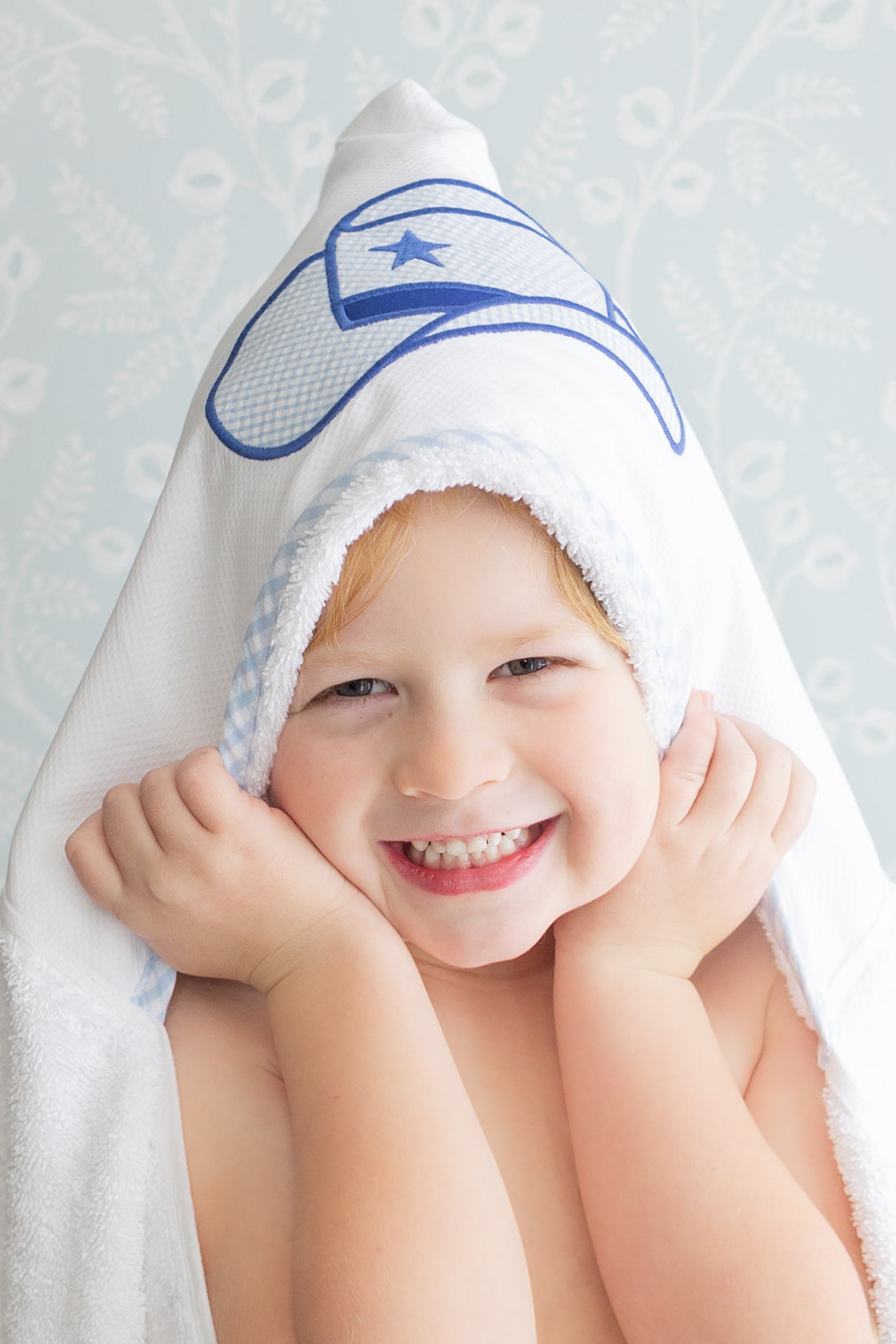 Child wearing hooded towel with a blue cowboy hat on the hood, 3 Marthas
