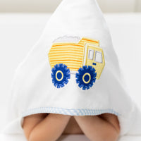 Child wearing a white hooded towel with a yellow dump truck design on a white background, 3 Marthas