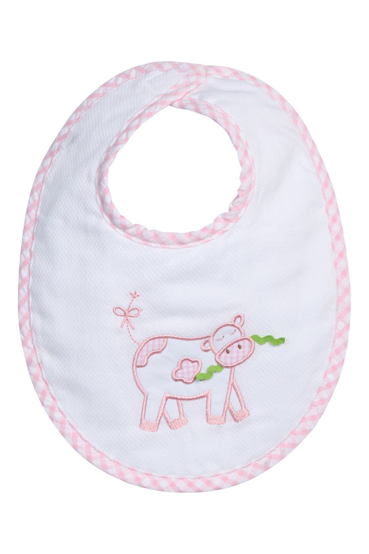 Baby bib with cow design and pink trim on a white background
