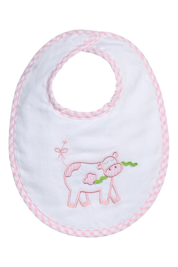 Baby bib with cow design and pink trim on a white background