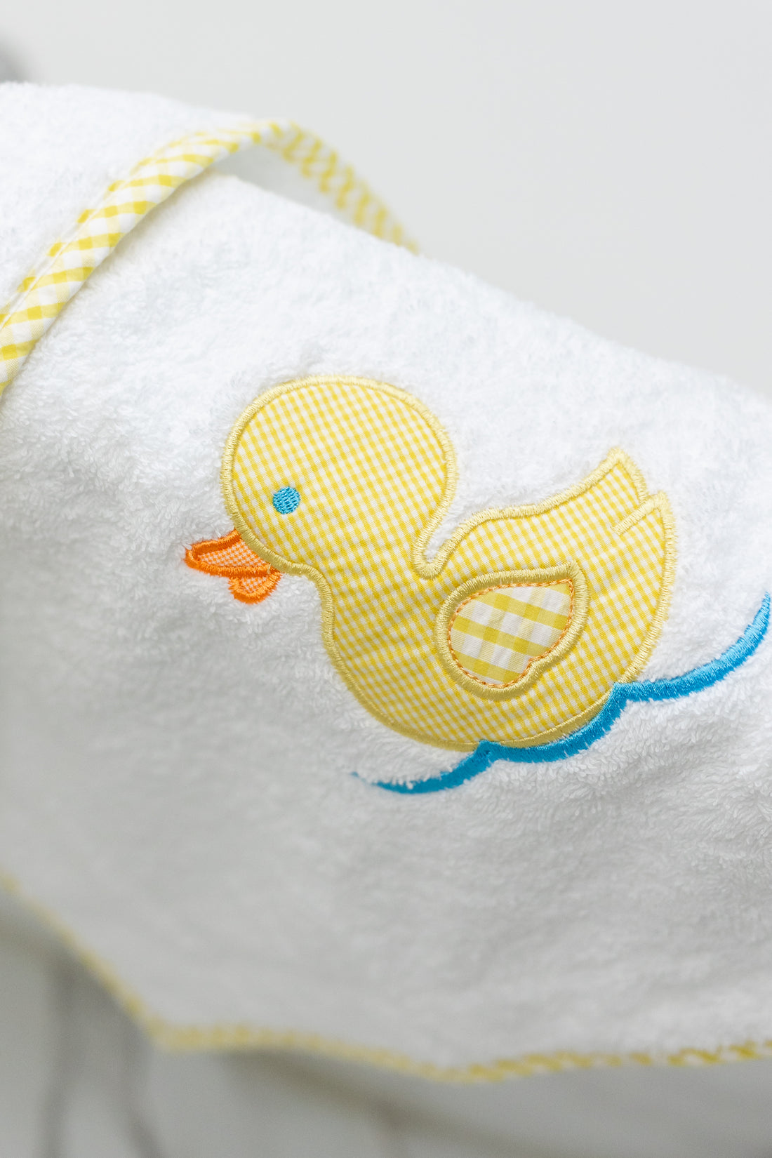 White bath mat with a yellow rubber duck design on side of tub, 3 Marthas
