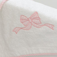 White terry bath mat with a pink gingham bow applique on side of tub, 3 Marthas