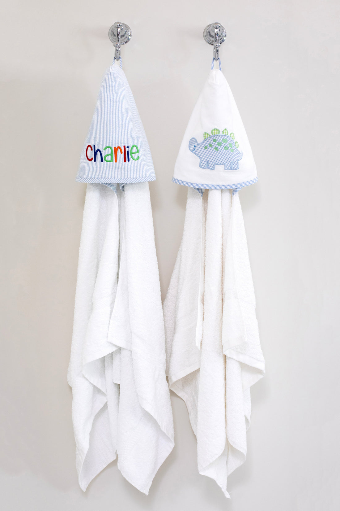 3 Marthas white terrycloth hooded towel with blue and green applique dino and blue check trim for boys. White terrycloth hooded towel with blue seersucker stripes for boys. 