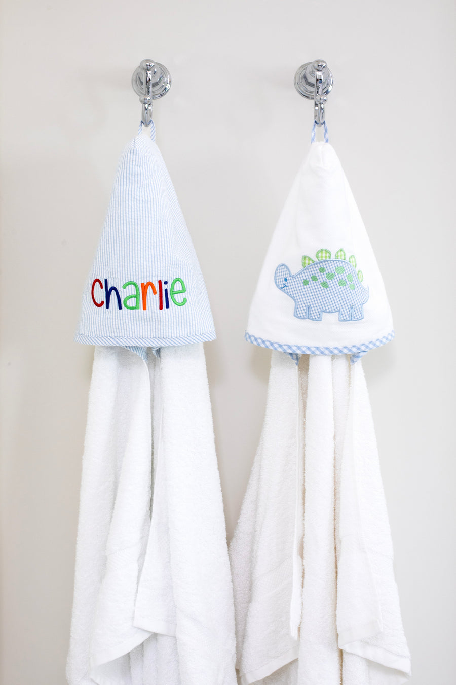 3 Marthas white terrycloth hooded towel with blue and green applique dino and blue check trim for boys. White terrycloth hooded towel with blue seersucker stripes for boys. 