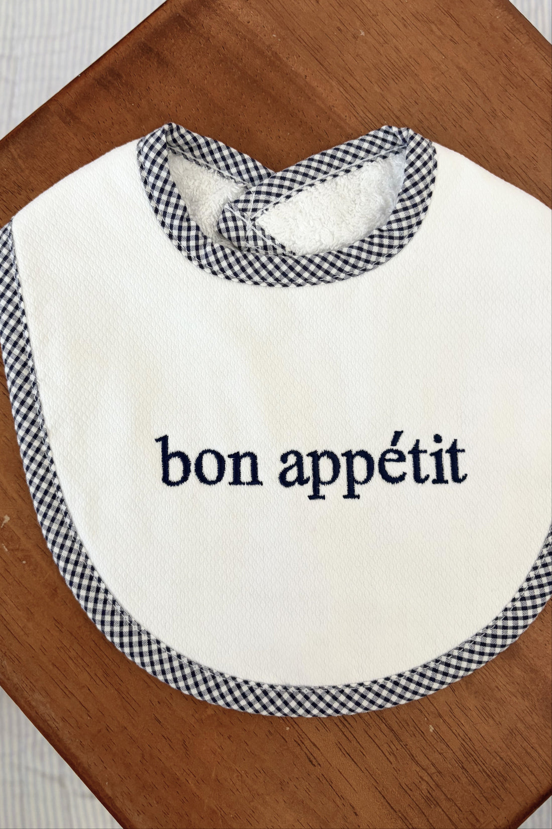 White bib with navy text &
