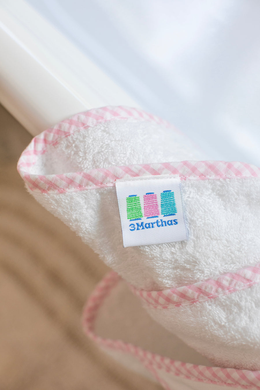 3 Marthas white terrycloth towel with pink check trim close up. 