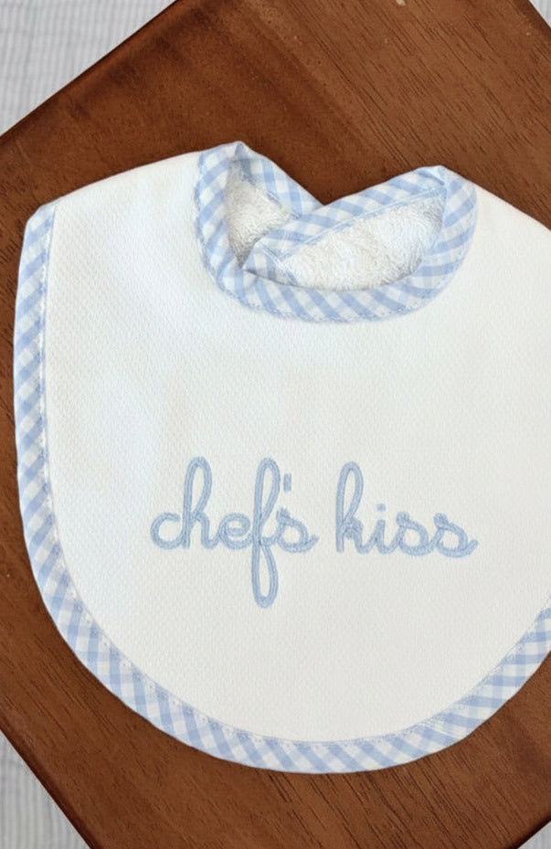 Baby bib with blue checkered trim and &